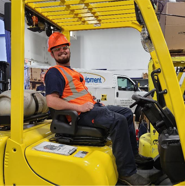 Smiling employee looking working with a lift