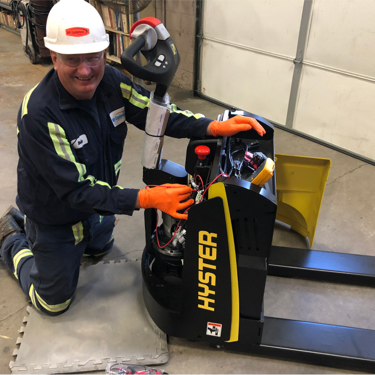 Technician fixing forklift