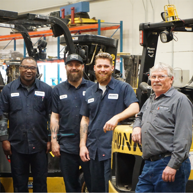 Group of happy employees in front of a lift