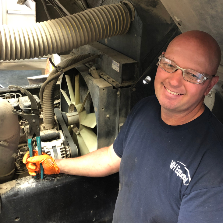 Smiling employee working on a machine